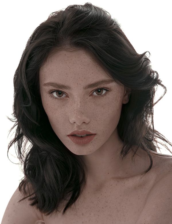 a woman with freckles on her body posing for the camera