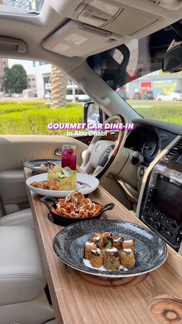 plates of food sit on a table in the back of a car