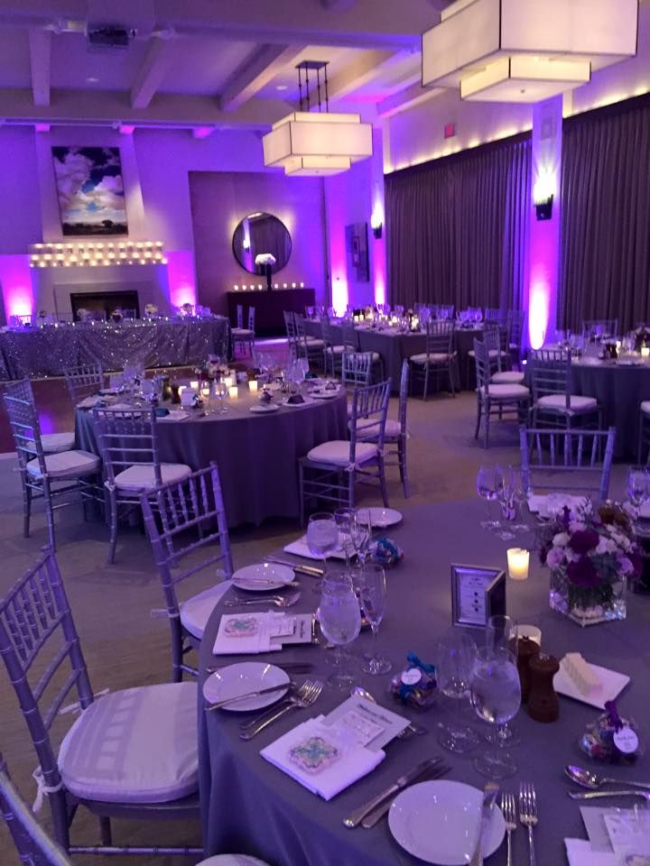 a banquet room set up with purple lighting