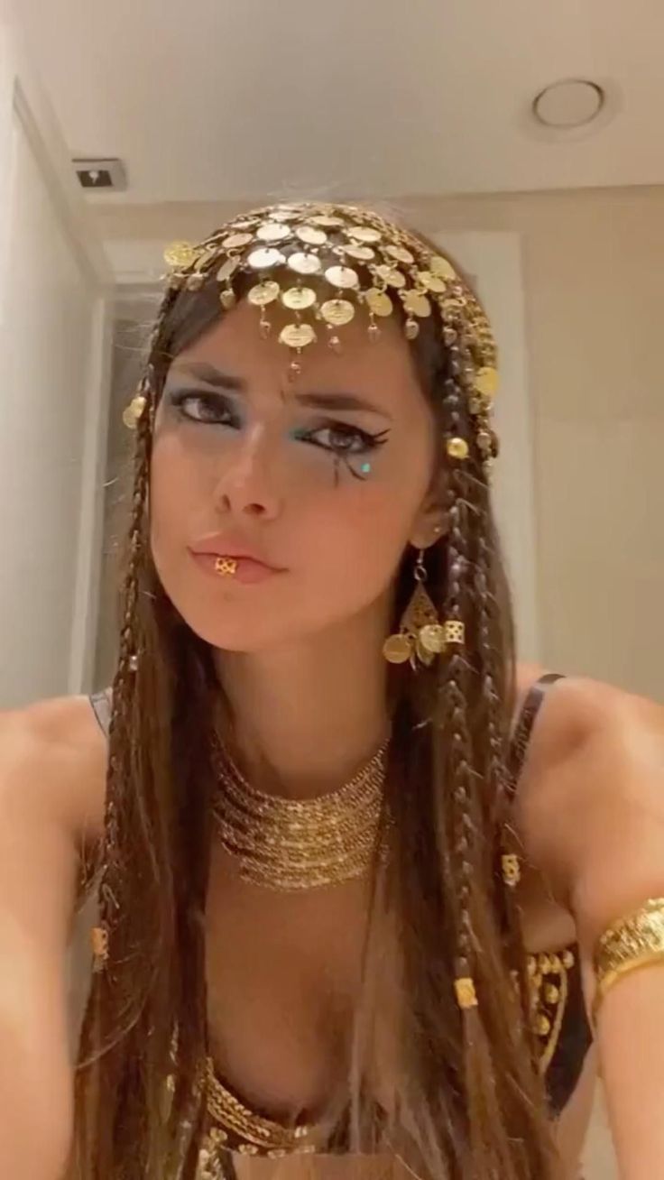 a woman with long hair wearing gold jewelry