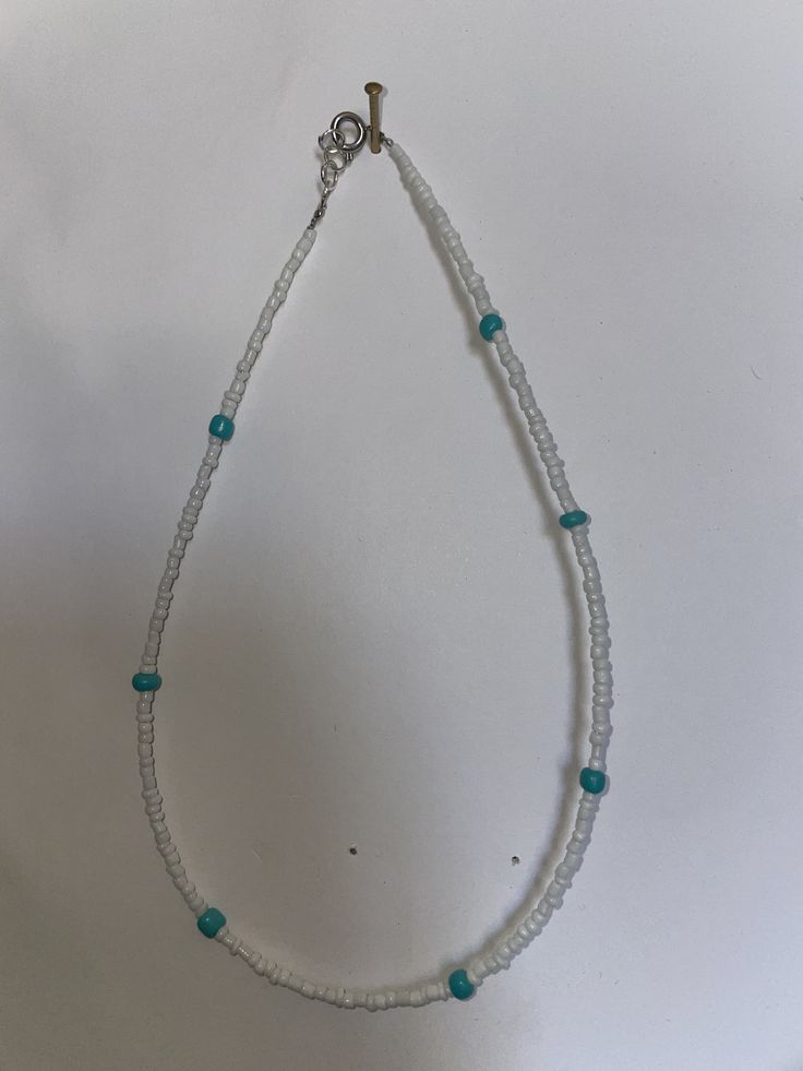 This necklace is a simple teal and white necklace. The white are the smaller beads and the teal beads are a little bigger. These are $7. These can be customized to any length or design. White Bohemian Beaded Necklaces With Letter Beads, Bohemian White Beaded Necklaces With Letter Beads, Adjustable Single Strand White Beads, White Beaded Necklace With Round Beads, White Single Strand Bohemian Beaded Necklace, White Bohemian Single Strand Beaded Necklace, Bohemian Single Strand White Beads, White Bohemian Single Strand Beads, Bohemian White Single Strand Beads