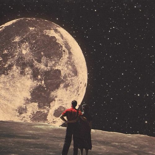 two people standing in front of the moon