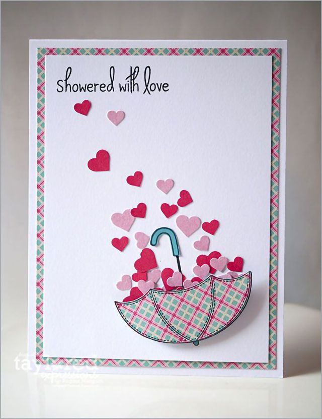 a card with an umbrella and hearts on it