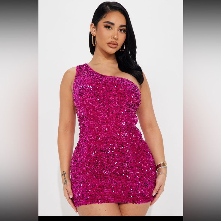 a woman wearing a pink sequin bodysuit with one shoulder and thigh high heels