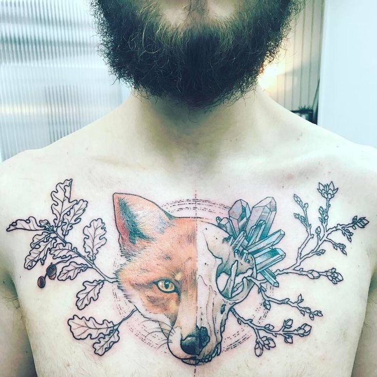 a man's chest with an image of a fox and flowers on his chest