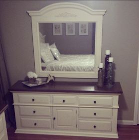 a white dresser with drawers and a mirror on it's side in a bedroom