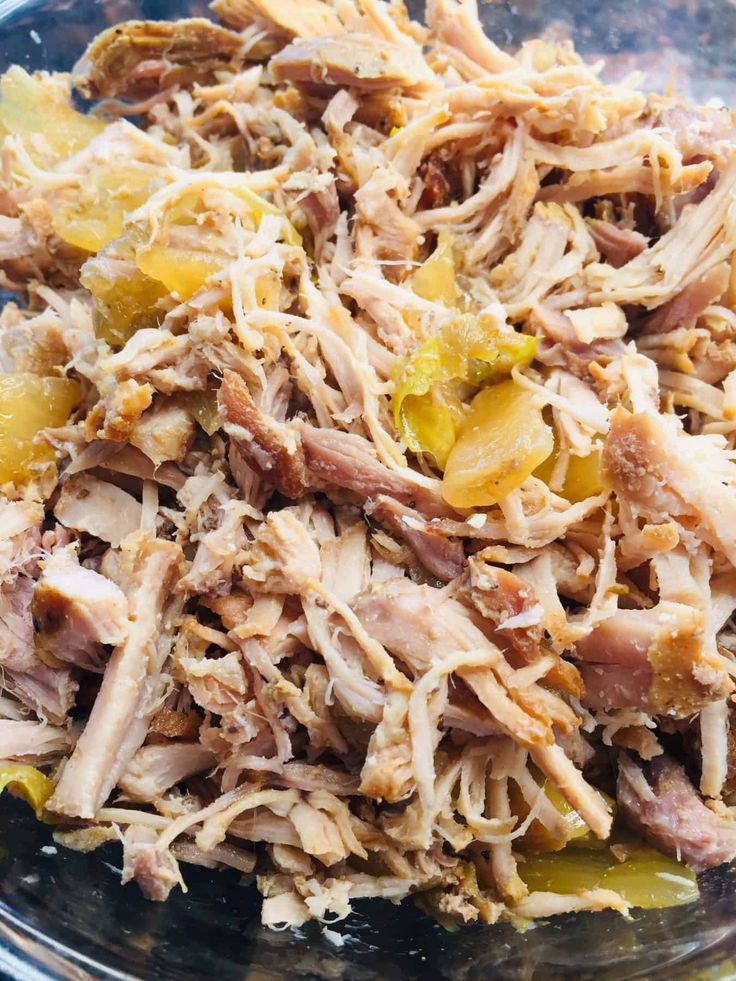 shredded meat and vegetables in a glass bowl