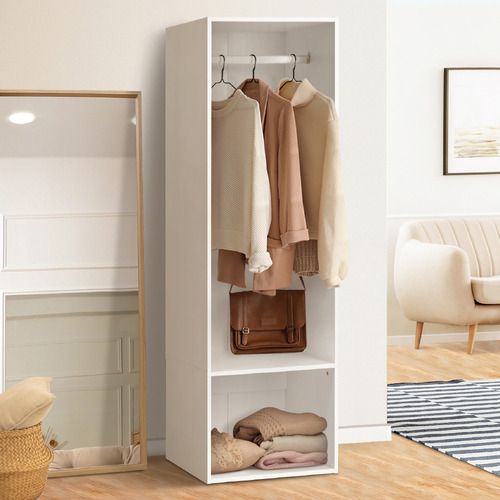 a white closet with clothes hanging on hooks and shoes in the bottom shelf next to it