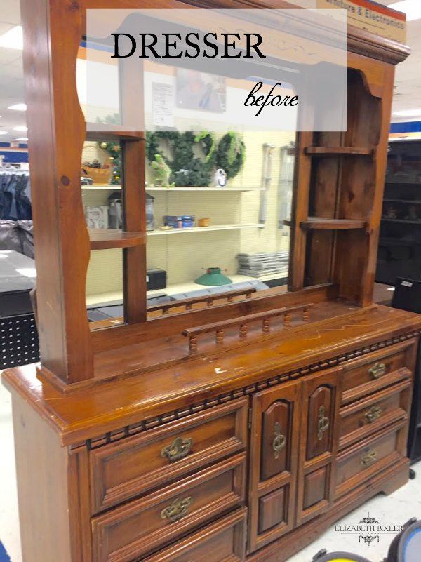 an old dresser is being displayed in a store