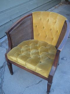 a yellow chair sitting on top of a sidewalk