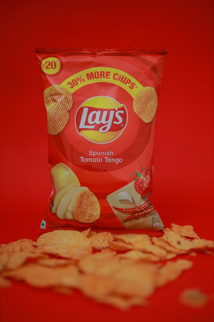 a bag of lays potato chips on a red background