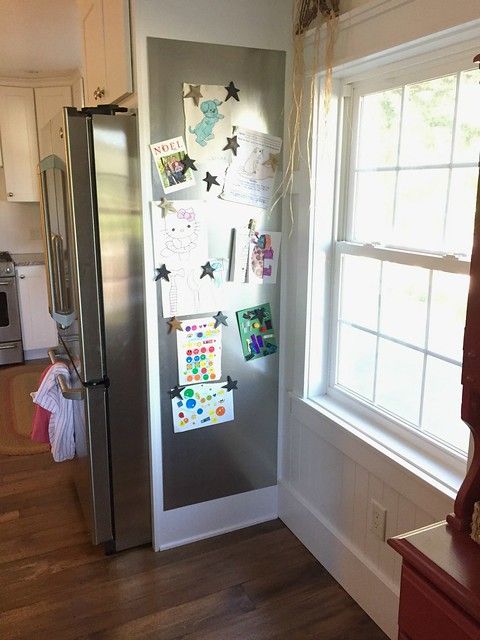 a refrigerator with magnets on it in a kitchen