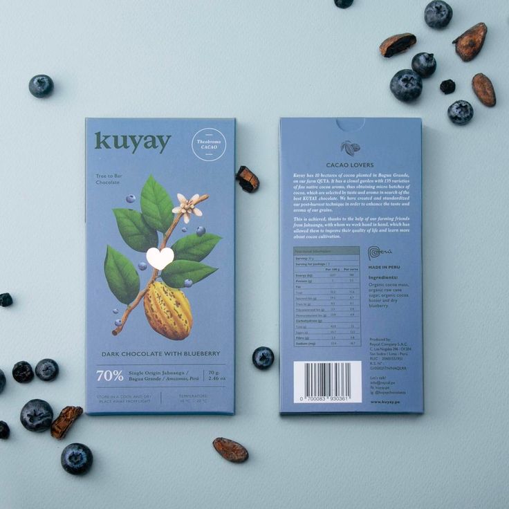 the book is laying next to some blueberries and almonds on a white surface