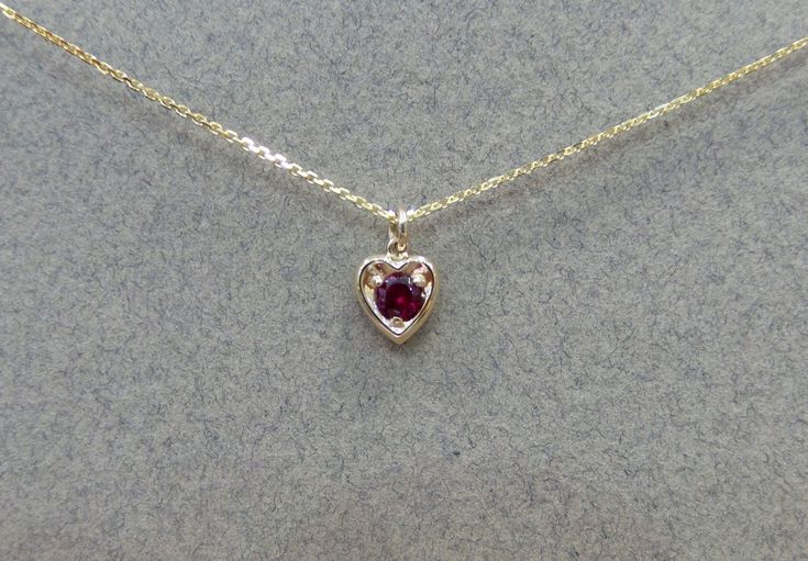 Ruby Necklace/ 14k Gold Heart Necklace/ Mini Heart Necklace/ Dainty Heart Necklace/ Gemstone Necklace/ July Birthstone/ Birthday Gift/ Valentines Gift/ Delicate Ruby Necklace Free Shipping within the USA METAL: 14K YELLOW GOLD 585 STONES: 0.12CT GENUINE RUBY STYLE: MINI HEART NECKLACE/ JULY BIRTHSTONE PURITY: 14K 585 SIZE: HEART IS 6.3MM BY 6.5MM AS IT IS WITH THIS ITEM ALL MY PIECES ARE HAND MADE. AND I STAND BEHIND EVERY PIECE. SATISFACTION GUARANTEED. FIND OUT ABOUT OUR LAYAWAY PAYMENT PLAN A 14k Gold Gemstone Heart Necklace For Anniversary, Heart-shaped Yellow Gold Birthstone Necklace For Valentine's Day, Valentine's Day Heart Shaped Yellow Gold Birthstone Necklace, Valentine's Day Heart-shaped Birthstone Necklace, Fine Jewelry Heart-shaped Birthstone Necklace, 14k Gold Birthstone Necklace For Valentine's Day, Mini Heart Necklace, Dainty Heart Necklace, Ruby Necklace