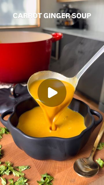 carrot ginger soup being poured into a bowl