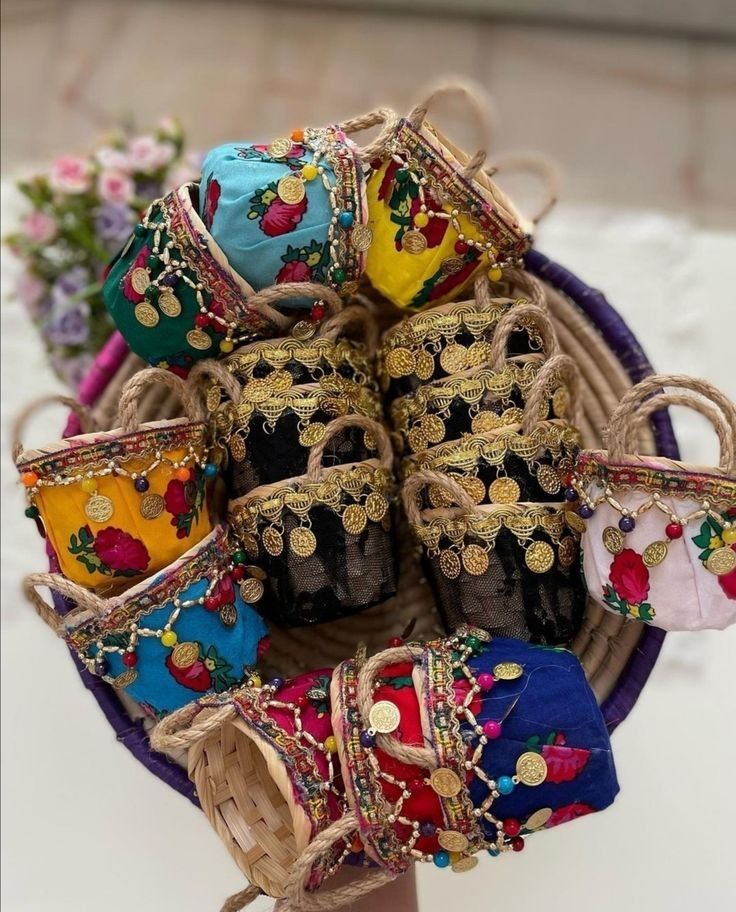 a basket filled with lots of different types of purses on top of a table