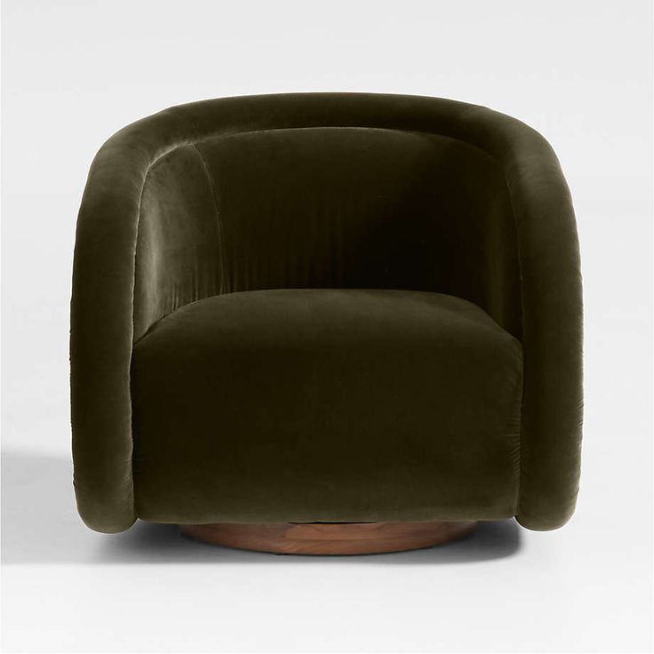 an olive green velvet chair with wooden base