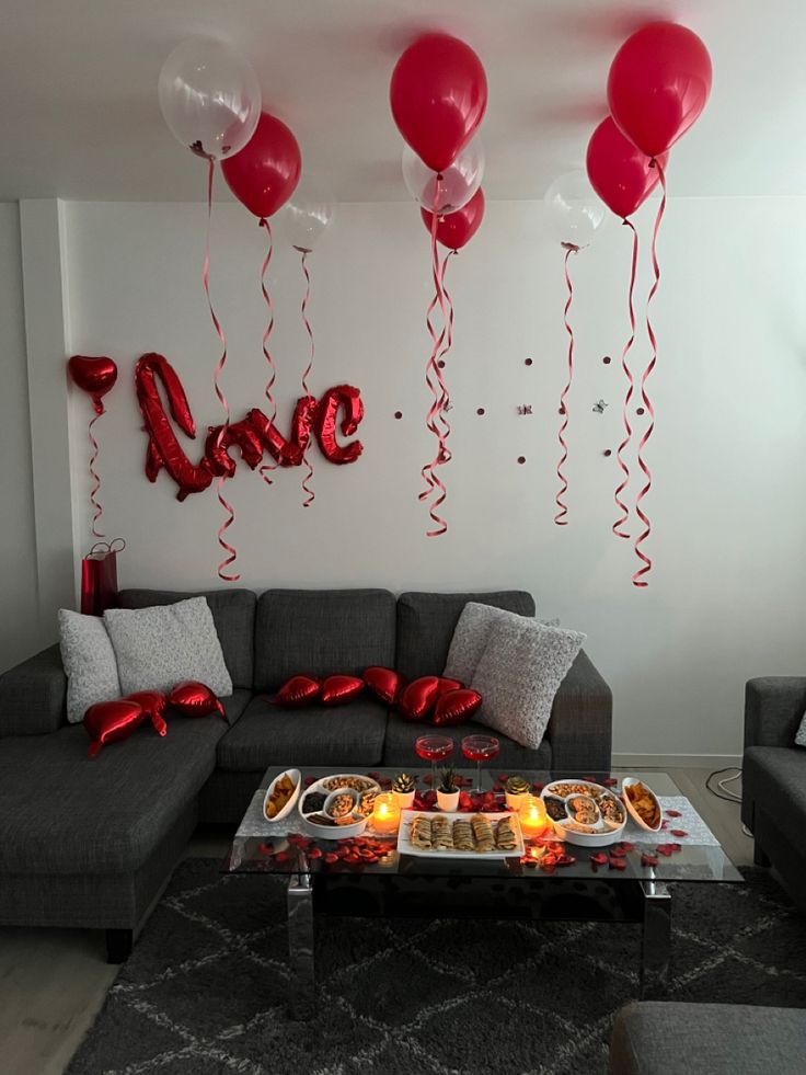 a living room filled with furniture and balloons