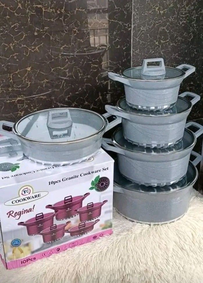 pots and pans stacked on top of each other in front of a cardboard box