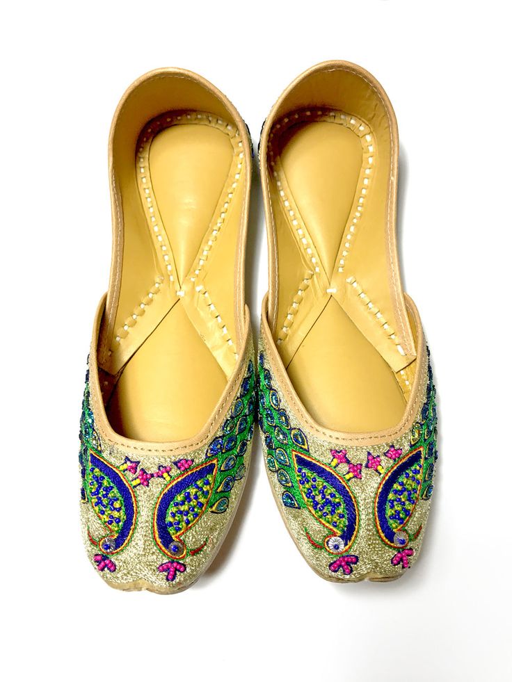 Ladies Punjabi Jutti flat shoes are made of genuine soft leather and exquisitely hand stitched with the finest materials and padded inner side of the sole for extra comfort. Each pair of Jutti/Mojari is handmade. There is no left and right and they will take the shape of the feet as you wear them. All our shoes run true to standard US shoe sizes and come in medium width. We recommend you select the shoe size based on your length of foot. Product Highlights:Fabric: Genuine Leather Sole, Silk base Embroidered Leather Flats With Flat Heel, Festive Handwork Leather Flats, Leather Embroidered Flats, Festive Leather Flats With Handwork, Embroidered Leather Slip-on Flats, Festive Embroidered Flats With Round Toe, Festive Embroidered Round Toe Flats, Festive Embroidered Leather Flats, Embroidered Multicolor Flats With Round Toe