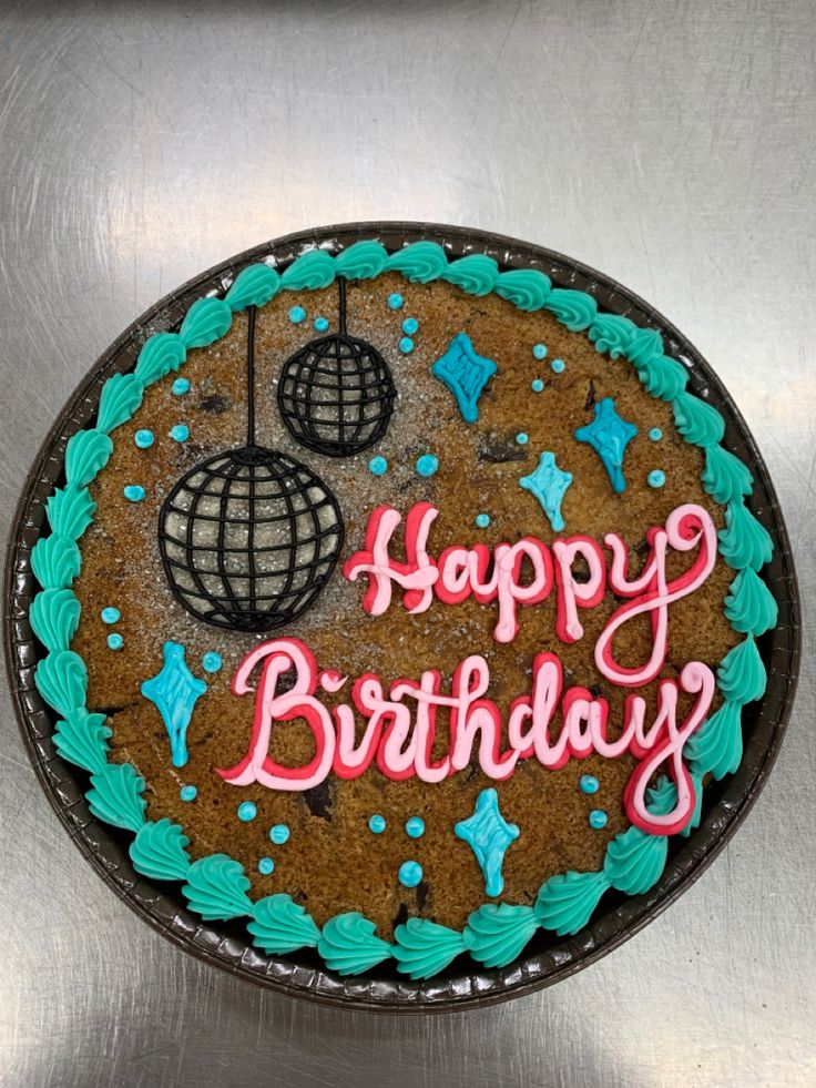 a birthday cake with the words happy birthday written on it in pink and blue icing