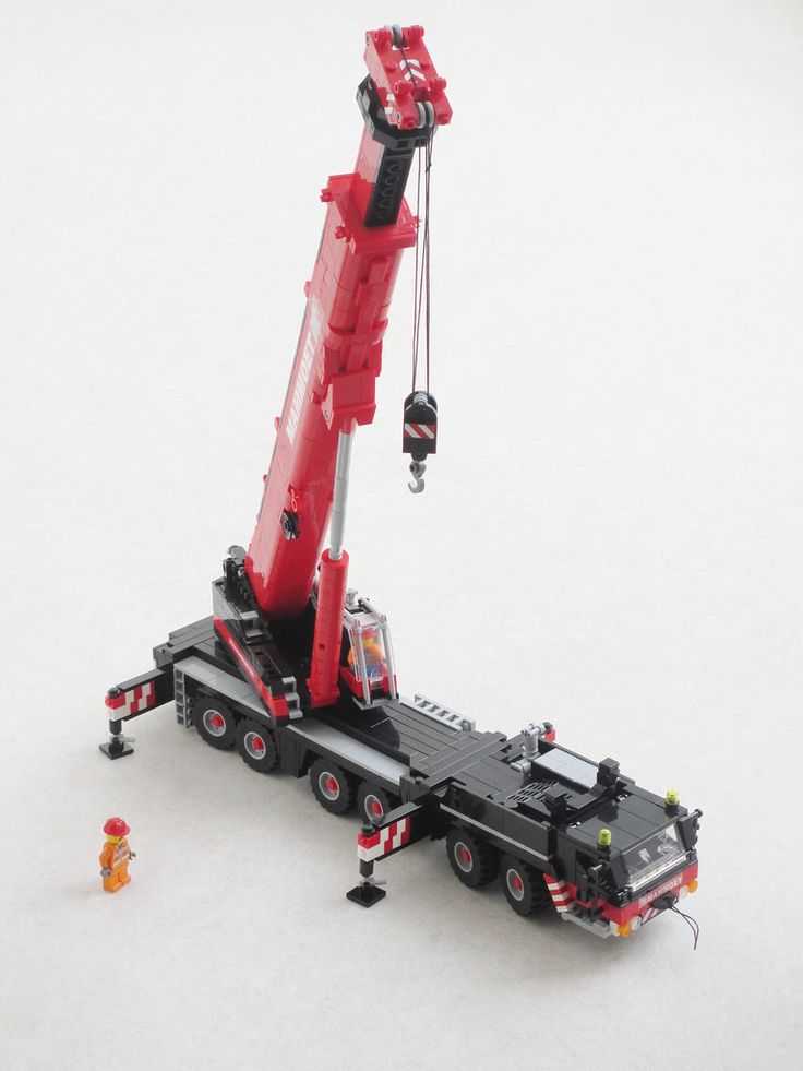 a lego crane is attached to the back of a semi - truck in the snow