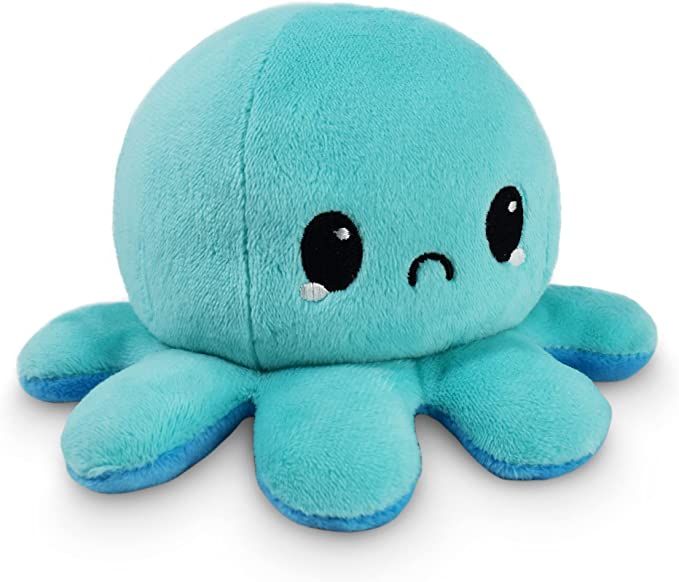 an octopus stuffed animal sitting on top of a white surface