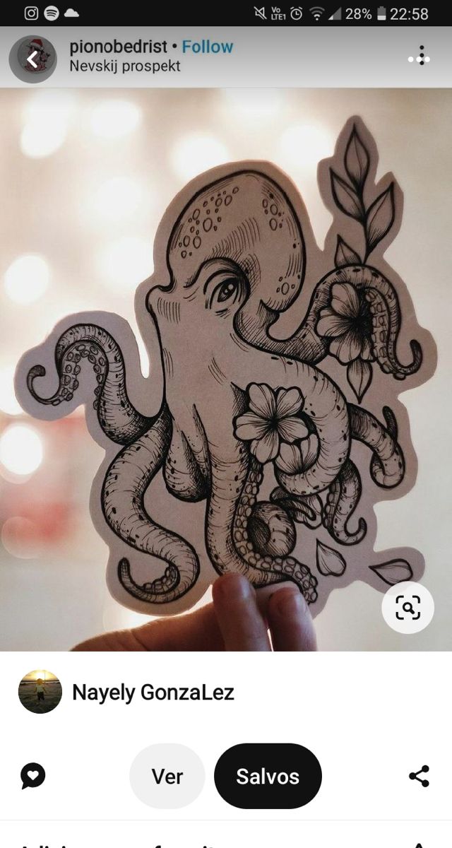 an octopus sticker with flowers and leaves on it's head is being held up