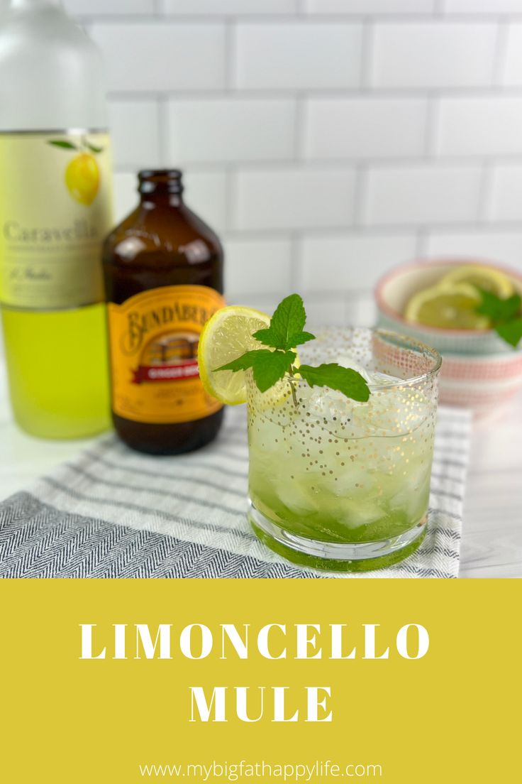 lemoncello mule with lime and mint garnish on the rim in front of bottles