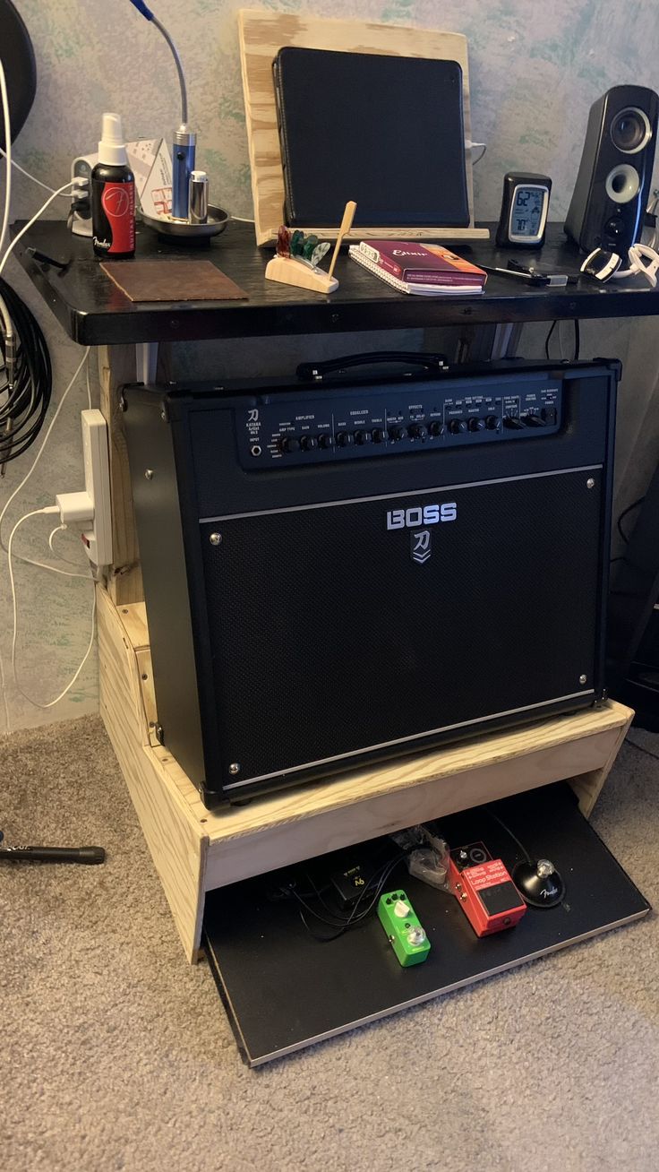 an amp sitting on top of a table in a room with other electronics around it