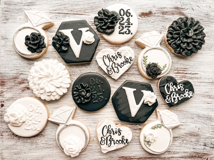 cookies decorated with black and white frosting are arranged on a table