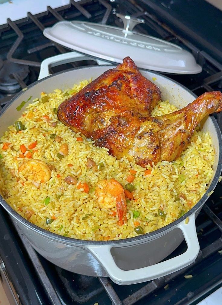 chicken and rice in a pan on the stove