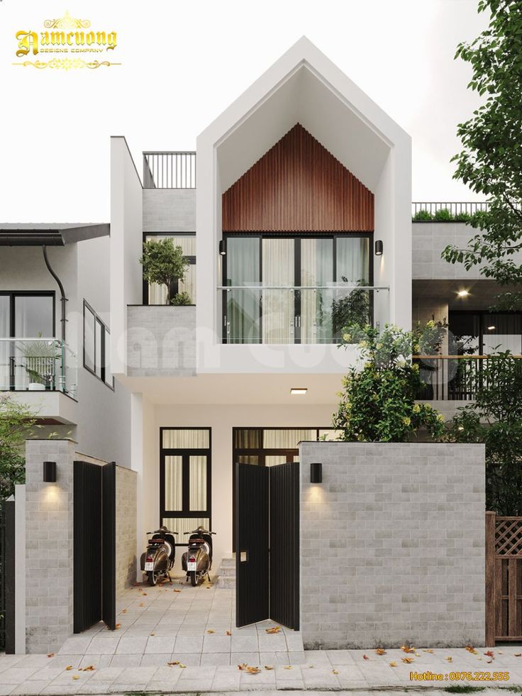 the front entrance to a modern house with black doors