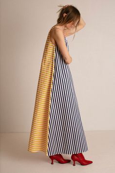 A line, maxi length dress with a simple scoop neck in a bold, colorblock stripe print. Gathers at the waist with a matching tie belt. Fabric is 100% cotton. Ella is 6' tall, 35" bust, 26" waist, 36" hip, and is wearing a size 2. Chic Spring Dresses With Contrast Stripes, Spring Color Block Maxi Dress, Chic Cotton Dress With Striped Hem, Striped Color Block Dresses For The Beach, Chic Summer Dresses With Striped Sleeves, Spring Cotton Dresses With Contrast Stripes, Cotton Spring Dresses With Striped Sleeves, Spring Cotton Dresses With Striped Sleeves, Spring Striped A-line Maxi Dress