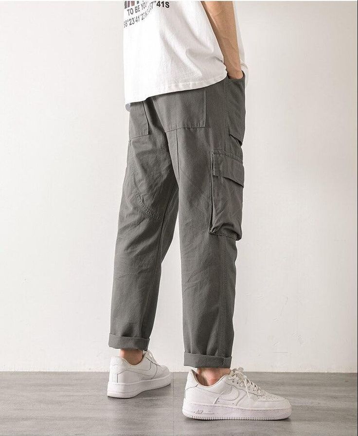 Step out in style with these straight leg cargo pants. Designed with an elasticated waistband and a functional drawstring, these pants are crafted from durable cotton. The cargo-style pockets on the leg add a touch of utilitarian chic, making them a versatile addition to any man's wardrobe. Elasticated waistband with drawstring Men's pants Cotton Cargo-style pockets on leg Straight leg Straight Leg Cargo Pants, Hip Hop Fashion 90s, 90s Fashion Grunge, Oversized Streetwear, Streetwear Grunge, Corsets And Bustiers, Cargo Style, Aesthetic Look, Cargo Skirt