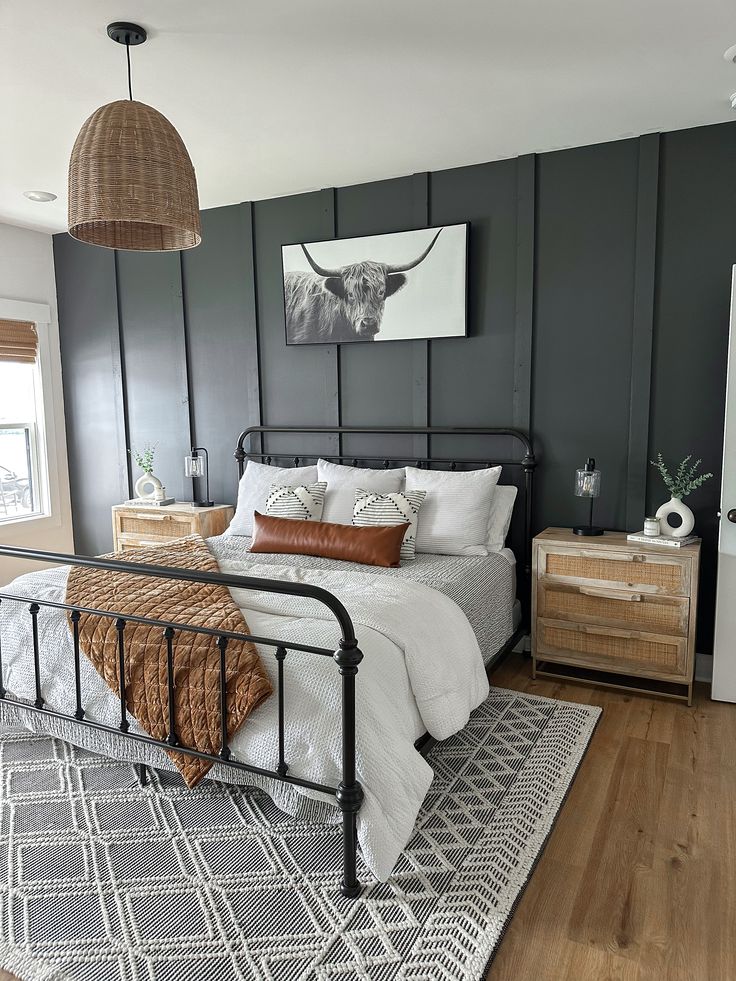 a bed room with a neatly made bed and two lamps hanging above the headboard