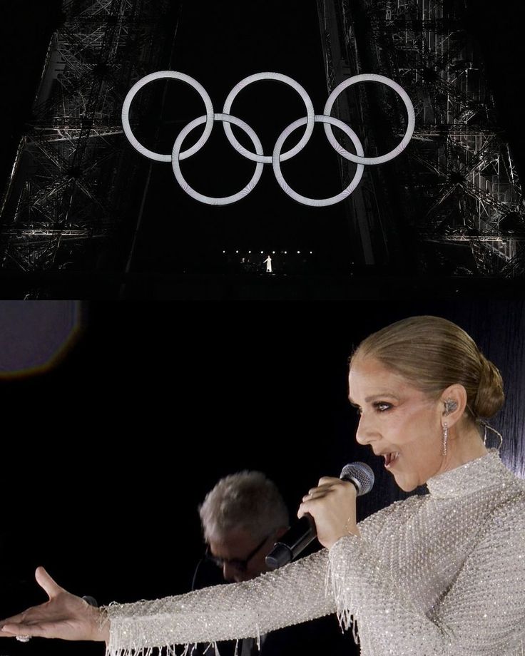 a woman holding a microphone while standing in front of an olympic symbol above her head