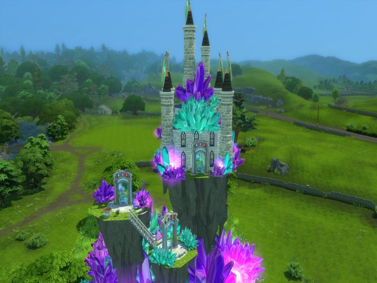 an aerial view of a castle in the middle of a lush green field with purple flowers