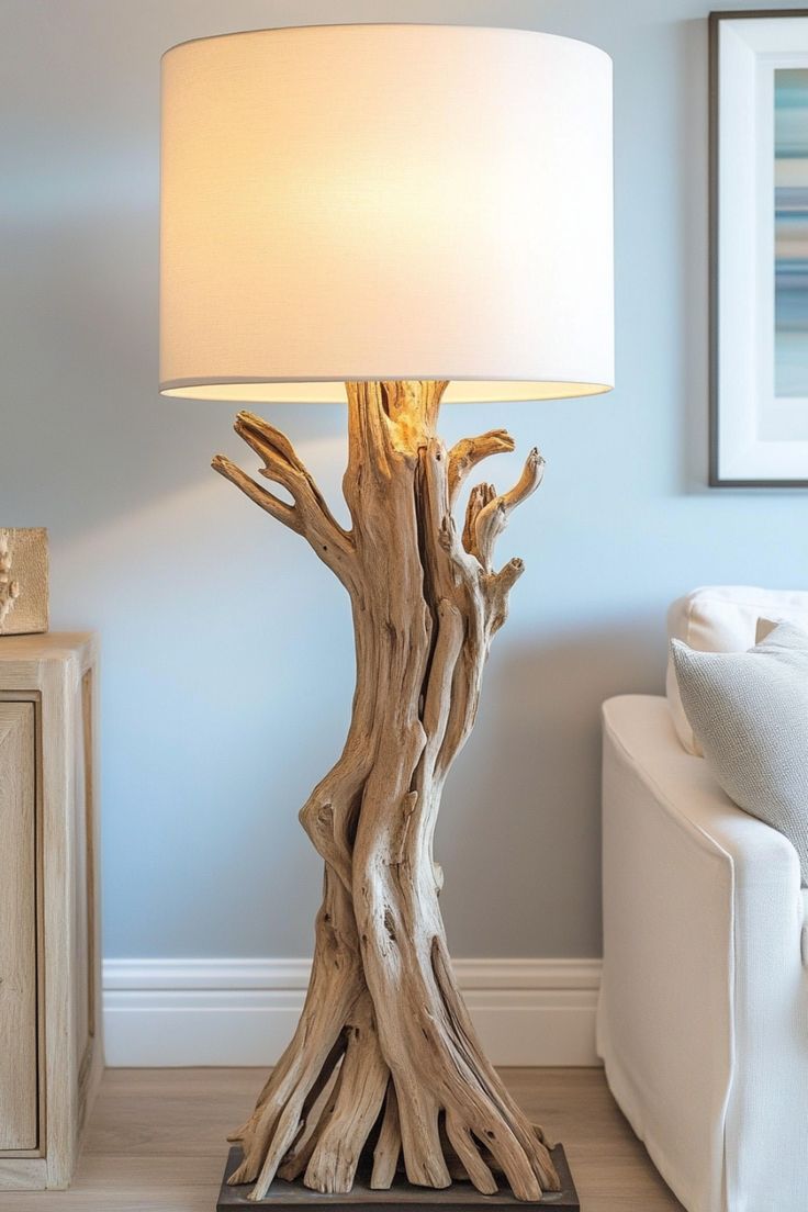 a lamp that is sitting on top of a wooden table next to a white couch