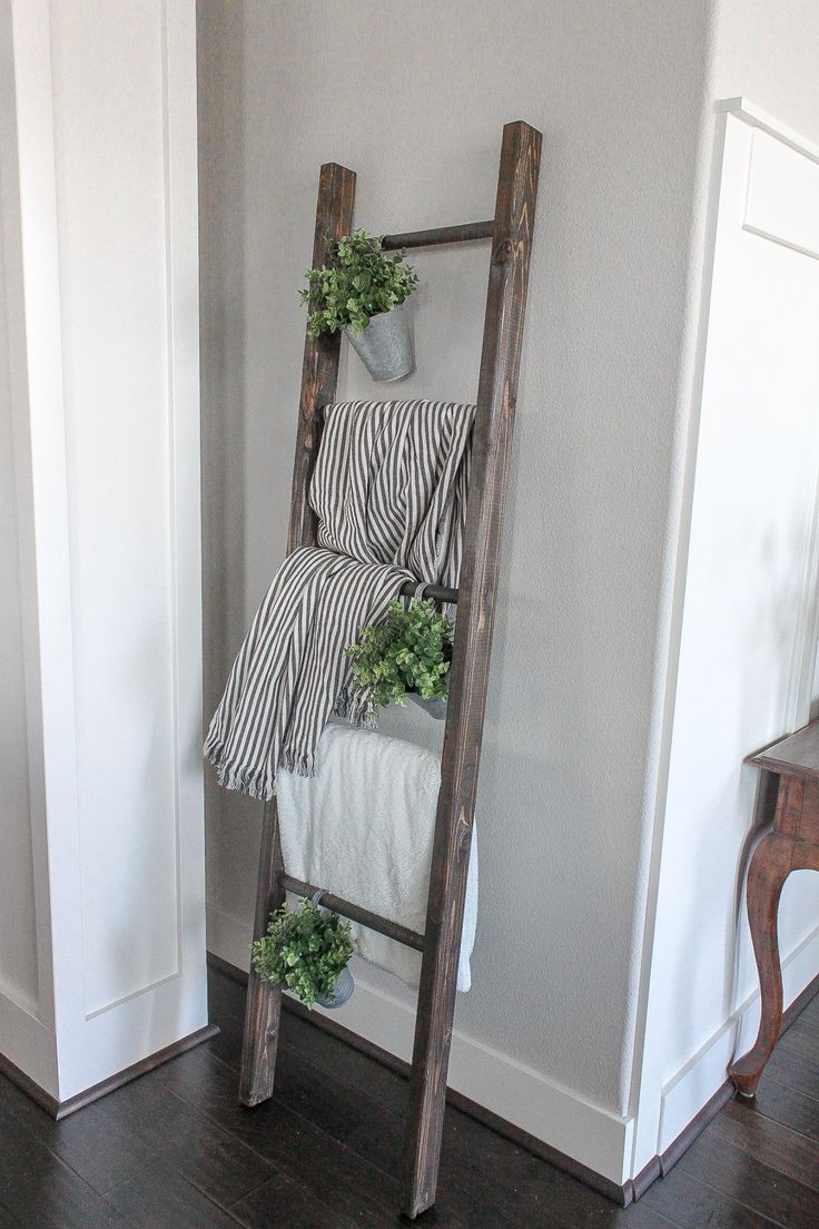 a ladder leaning against the wall with plants on it