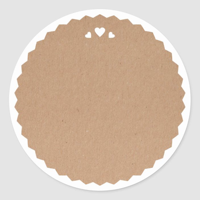 a round sticker with hearts in the center on a white background and brown paper