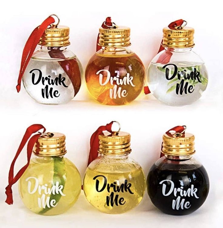 four different colored bottles with drink me written on them