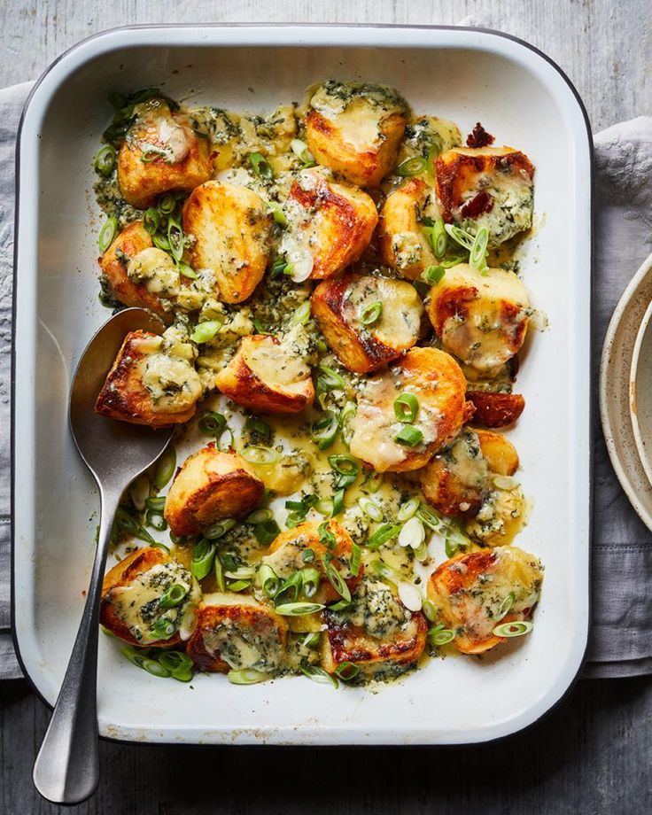 a casserole dish with potatoes, broccoli and cheese