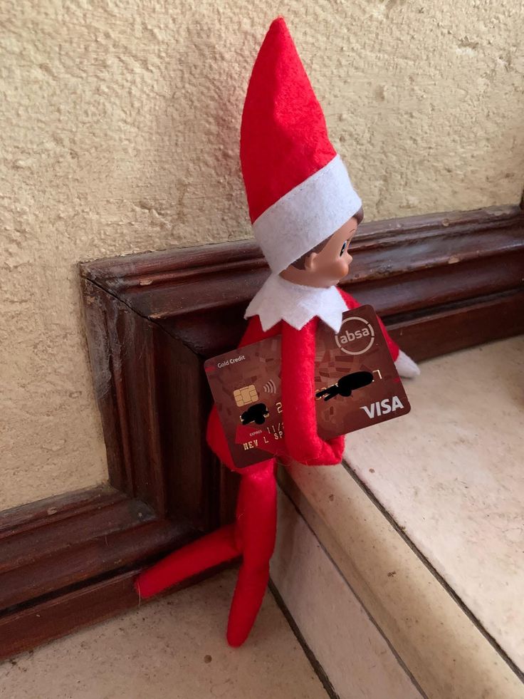 an elf with a credit card in his hand