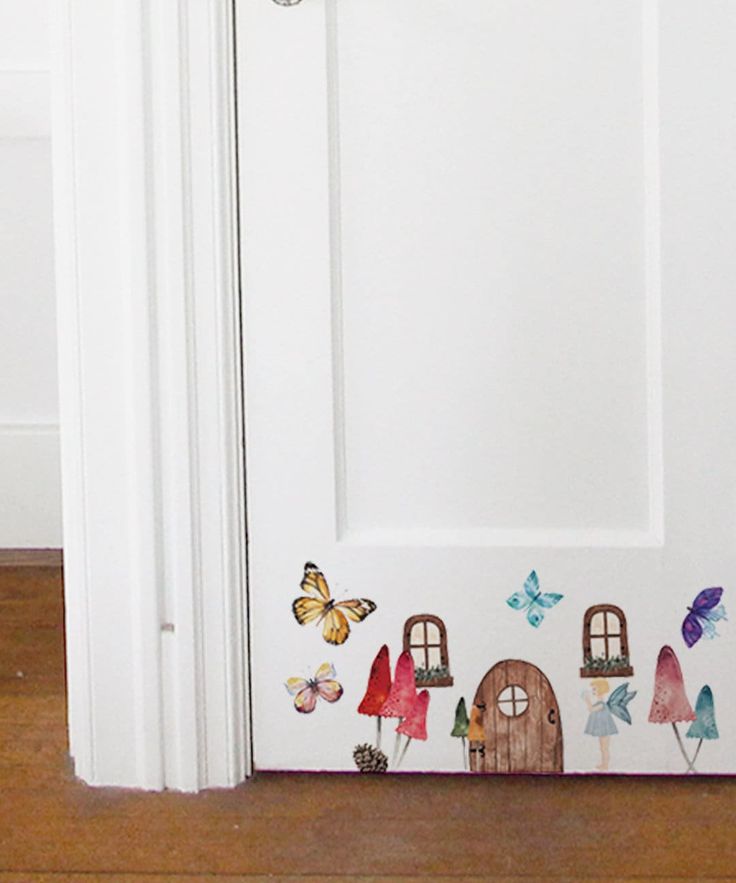 the door is decorated with colorful butterflies and small houses on it's front panel