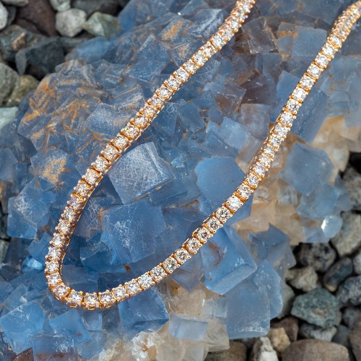 This stunning necklace is accented with one hundred thirteen (113) round brilliant cut diamonds set into four-prong settings totaling over 20 carats. The necklace measures 4.6mm wide, 4.1mm thick and an overall length of 18.5 inches. The necklace is finished with a hidden box clasp and safety. Luxury Rose Gold Tennis Necklace For Formal Occasions, Formal Rose Gold Diamond Cut Tennis Necklace, Rose Gold Diamond Necklace With Moissanite And Diamond Accents, Formal Rose Gold Tennis Necklace With Diamond Cut, Formal Rose Gold Diamond Tennis Necklace, Rose Gold Cubic Zirconia Diamond Necklace With Pave Setting, Formal Fine Jewelry Rose Gold Tennis Necklace, Rose Gold Diamond Tennis Necklace For Formal Occasions, Dazzling Rose Gold Diamond Accents Necklace