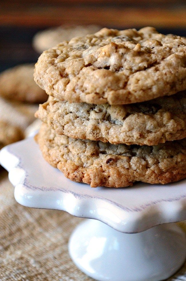 three cookies stacked on top of each other in a white plate next to another cookie