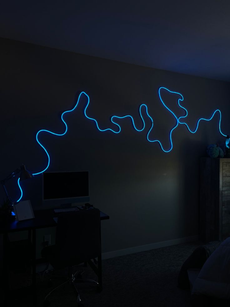 a bed room with a neatly made bed and a neon blue light on the wall