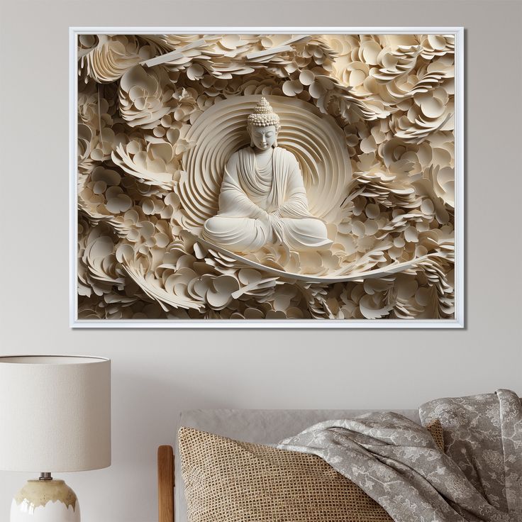 a white buddha statue sitting on top of a bed next to a wall mounted art piece