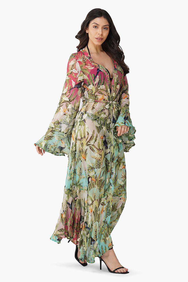 Sheer swim cover-up Printed lurex viscose georgette Front open Maxi length Full sleeves with ruffles Ruffles at the hem Soak up the sun in style with the Tropical Toucan Front Open Cover Up! This sheer swim cover-up is a statement piece that's as playful as it is chic.Made from printed Lurex viscose georgette, it features a vibrant tropical design that feels both fresh and flirty. The front open design and full sleeves with ruffles add a dramatic flair, while the ruffles at the hem give it an ec Maxi Length Beachwear Cover-up For Brunch, Tropical Long Sleeve Cover-up For Beach Season, Tropical V-neck Cover-up For Pool, Long Sleeve Tropical Print Swimwear For Beach, Tropical Ruffled Beach Dress, Beach Season Ruffled Beach Dress, Ruffled Beach Dress For Beach Season, Flowy Long-sleeve Cover-up For Beach Party, Flowy Long Sleeve Cover-up For Beach Party